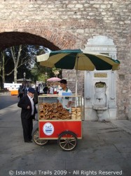 Street vendor selling simit and açma.